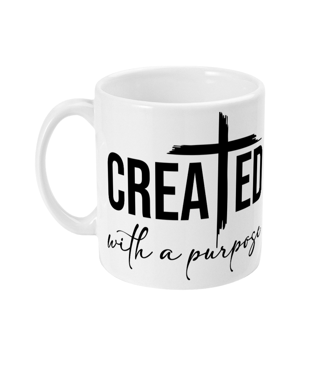 White 11oz mug with the phrase "Created with a purpose" and a cross design on the side.
