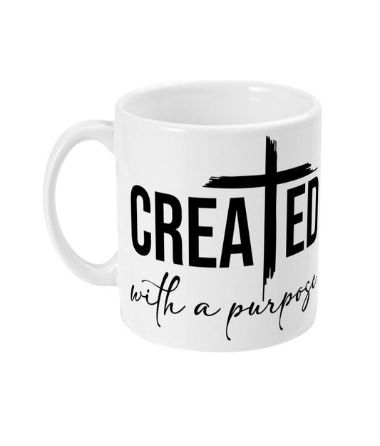 White 11oz mug with the phrase "Created with a purpose" and a cross design on the side.